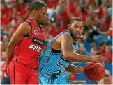  ?? PHOTO: GETTY IMAGES ?? DJ Newbill works to the basket against Bryce Cotton of the Wildcats during the Breakers’ win in Perth earlier this month.