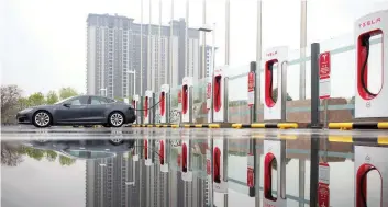  ?? Reuters ?? A Tesla car is seen being charged at a charging point in Beijing, China, in this file photo.—