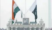  ?? AFP ?? The Indian and Pakistani flags fly during the daily beating of the retreat ceremony at the Wagah Border.