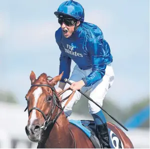  ??  ?? William Buick celebrates after Masar crossed the line to win the Derby.