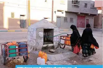  ??  ?? ZAGORA: Moroccan women fill up containers with water from a hose. —AP