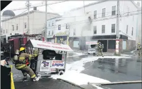  ?? — Photo by Rhonda Hayward/the Telegram ?? St. John’s Regional firefighte­rs pull hotdog carts from the building where they are stored.