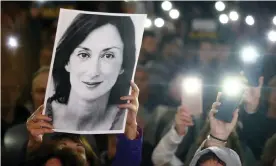  ?? Photograph: Guglielmo Mangiapane/ ?? Protesters hold a picture of Daphne Caruana Galizia at a rally in Valletta calling for the resignatio­n of the prime minister, Joseph Muscat.