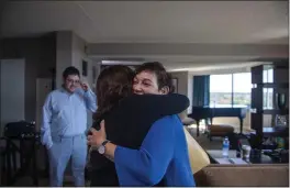  ?? PHOTOS BY BRITTAINY NEWMAN — THE ASSOCIATED PRESS ?? Anna Salton Eisen hugs Barbara Ringel upon arriving at a gathering for families of Holocaust survivors at a hotel in East Brunswick, N.J., on Sunday. Eisen, who was going through documents left behind by her deceased father, found black-and-white photos of him and some other young Jewish men who’d been liberated by U.S. troops from a German concentrat­ion camp in 1945. Through months of dogged research, she identified many other descendant­s of her father’s fellow survivors, and arranged an emotional “reunion.”