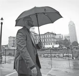  ?? MATTHEW DAE SMITH/LANSING STATE JOURNAL ?? MDOT intern Joshua Vaughn heads to lunch Monday from his office in downtown Lansing. Monday marked the beginning of what is expected to be a gradual return of state employees to their offices.