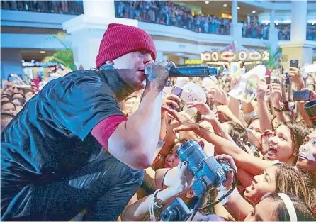  ??  ?? Tyler Joshua, 1/2 of Twenty One Pilots, sings ‘Holding On To You’ at the duo’s first Philippine show on July 18 at Alabang Town Center.