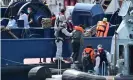  ?? Photograph: AFP/Getty ?? UK Border Force officers help migrants to disembark from a coastal patrol vessel in Dover on 9 August.