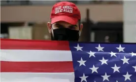  ?? Photograph: Marcio José Sánchez/AP ?? A supporter of President Trump waves a flag in Los Angeles.