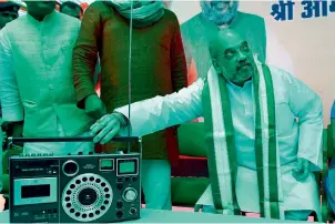  ?? PTI ?? BJP president Amit Shah listens to Prime Minister Narendra Modi’s Mann Ki Baat radio programme at Guru Ravi Das Dham at R K Puram in New Delhi on Sunday. —