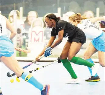  ??  ?? Abosaide Cadogan (center) of Guyana tries to maintain possession while being pursued by several Uruguay defenders in their 2021 Indoor Pan Am Cup (IPAC) fixture yesterday.