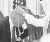  ?? EVAN VUCCI, AP ?? Saudi King Salman presents President Trump with the Collar of Abdulaziz Al Saud medal at the Royal Court Palace on Saturday.