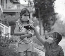  ?? Hyoung Chang, The Denver Post ?? Ivy Millhouser, 8, left, and her sister Vivian, 11, usually attend summer camps at the Denver Zoo and the City Park Rec Camp.