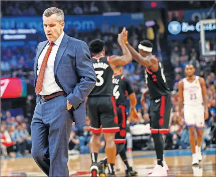  ?? [NATE BILLINGS/ THE OKLAHOMAN] ?? Oklahoma City coach Billy Donovan walks on the court at the beginning of a timeout as Toronto players high five during the first quarter of Wednesday night's game at Chesapeake Energy Arena. Oklahoma City's late rally fell short in a 130-121 loss.