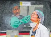  ?? YOGENDRA KUMAR/HT PHOTO ?? A health worker takes a sample of his colleague at a civil hospital in Gurugram on Wednesday.