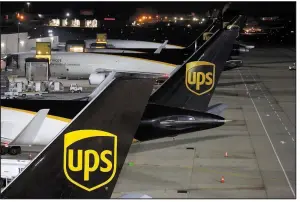  ?? Bloomberg file photo ?? The United Parcel Service Inc. logo is displayed on the tail section of cargo jets on the tarmac at the UPS Worldport facility in Louisville, Ky.