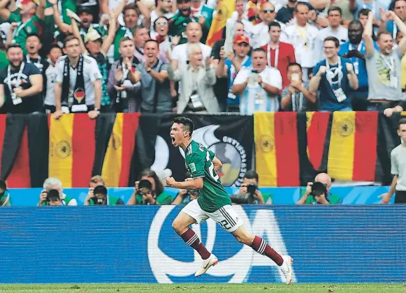  ?? FOTOS: AFP/AP ?? Con el mejor fondo, el tapizado de las banderas alemanas, Hirving Lozano grita el gol más importante de su corta carrera. El Chucky tiene 22 años y juega en el PSV.