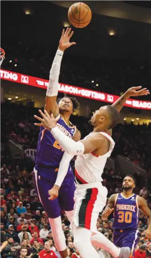  ?? PICTURE: USA TODAY Sports ?? Phoenix Suns forward Richaun Holmes (left) defends the basket against Portland Trail Blazers guard Damian Lillard during the second half at Moda Center.