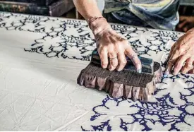  ??  ?? EXPERTISE: Ever seen fabrics stamped by hand? In Rajasthan, they dip wooden blocks that are carved by hand in buckets of natural plant dyes to create countless such patterns. Below: A weaver at his loom creating an already exquisite-looking Banarsi sari