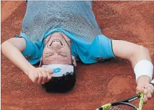  ?? MICHEL EULER
THE ASSOCIATED PRESS ?? Italy’s Marco Cecchinato lays on the clay after beating Serbia’s Novak Djokovic during their quarter-final match at the French Open .