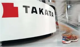  ?? ASSOCIATED PRESS FILE PHOTO ?? A visitor walks past the logo of Takata Corp. at a Toyota showroom in Tokyo.