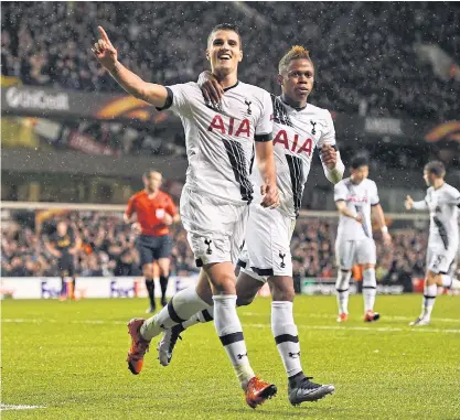  ??  ?? Tottenham’s Erik Lamela, left, celebrates scoring their third goal and completing his hat-trick with Clinton Njie.