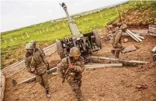  ?? Vahan Stepanyan / PAN photo via Associated Press ?? Army artillerym­en prepare to open fire on positions in NagornoKar­abakh, Azerbaijan, on Tuesday. The region is part of Azerbaijan but under the control of local ethnic Armenian forces.