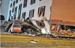  ?? Photo: AFP ?? A damaged vehicle stands in rubble outside the Marshal Hotel in Hualien, eastern Taiwan early on February 7, 2018, after a strong earthquake struck the island.