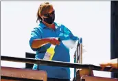  ?? RANDY VAZQUEZ — STAFF ARCHIVES ?? A worker disinfects one of the rides at the Santa Cruz Beach Boardwalk in Santa Cruz on April 1.