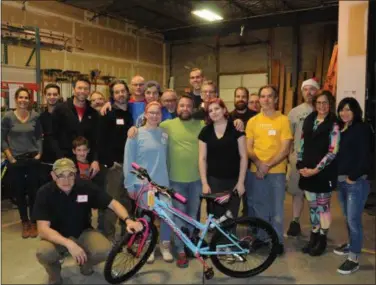  ?? SUBMITTED PHOTO ?? Volunteers at last year’s 100 Wheels Project. Pine Street Carpenters will host its 11th annual bike-build this coming Thursday, when volunteers will assemble 100 bikes for children in the community.