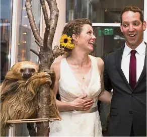  ?? — TNS ?? Geiger (centre) and Sperling at their wedding reception at Como Zoo, with Stefon the sloth, which was a hit with guests.