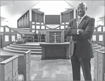  ?? AP PHOTO ?? Rev. Raphael Warnock stands in the sanctuary of Ebenezer Baptist Church in Atlanta. Warnock is senior pastor of the congregati­on once led by the Rev. Martin Luther King Jr.