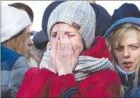  ?? AP PHOTO ?? A woman reacts after laying flowers for the victims of a fire in a multi-storey shopping center in the Siberian city of Kemerovo, about 1,900 miles east of Moscow Monday.