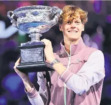  ?? — AFP photo ?? Sinner celebrates with the Norman Brookes Challenge Cup trophy after defeating Medvedev in the men’s singles final match on day 15 of the Australian Open tennis tournament in Melbourne.