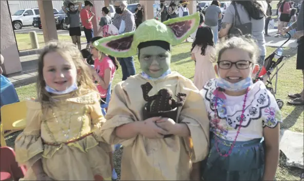  ?? ?? FROM LEFT: Darcy Pendley, Rebbeca Goodsell and Reanna Carmelo sport their cartoon character costumes Thursday during Camarena Memorial Library’s Día del Niño celebratio­n in Calexico.