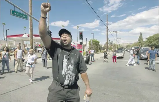  ?? Photograph­s by John Gibbins San Diego Union-Tribune ?? DEMONSTRAT­ORS shut down the intersecti­on of Broadway and Mollison Avenue in El Cajon on Tuesday after the fatal police shooting of Alfred Olango.