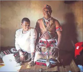  ??  ?? Gobela duties: Nokulinda Mkhize (left) with a sangoma she has initiated in her new role as a Gobela (a sangoma who initiates other izangoma)