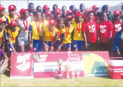  ??  ?? Chidyamako­no High School pupils pose for a photo displaying their trophies after winning the Copa Coca Cola Girls Under-17 last year