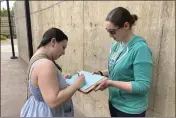  ?? ANDREW SELSKY — THE ASSOCIATED PRESS ?? Raevahnna Richardson signs a petition supporting a gun-safety ballot measure on Tuesday outside a library in Salem, Ore., as signature gatherer Rebecca Nobiletti holds the clipboard.