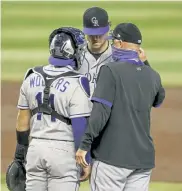  ?? Darryl Webb, The Associated Press ?? Colorado’s Tony Wolters and pitching coach Steve Foster talk to Kyle Freeland during a rough first inning. Wolters has earned the trust of his pitchers but came up short at the plate.