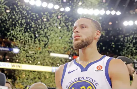  ?? (AP PHOTO/MARCIO JOSE SANCHEZ) ?? VICTORY SHOWER. Confetti falls as Golden State Warriors' Stephen Curry walks off the court at the end of Game 5 of the team's NBA basketball second-round playoff series against the New Orleans Pelicans on Tuesday, May 8, 2018, in Oakland, Calif. Golden...