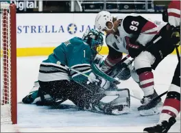  ?? JOHN HEFTI — THE ASSOCIATED PRESS ?? Sharks goaltender Alexei Melnichuk (1) guards against a shot by Arizona Coyotes center Lane Pederson (93) during the second period Saturday night in San Jose.