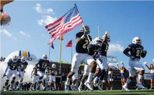  ?? STAFF FILE PHOTO BY DOUG STRICKLAND ?? The University of Tennessee at Chattanoog­a football team takes the field during the Mocs’ home game against the Mercer Bears at Finley Stadium on Oct. 8, 2016.