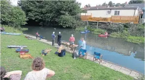  ?? PHOTO: JANET RICHARDSON ?? Members of Cleethorpe­s Model Boat Associatio­n sail their craft watched by a paddleboar­der and kayaker.