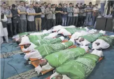  ?? AP ?? Un grupo de palestinos presencia los funerales de 13 milicianos de Hamas ayer, en Gaza.