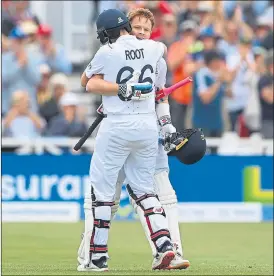  ?? ?? Ollie Pope receives a big hug from Joe Root after reaching his century at Trent Bridge
yesterday
