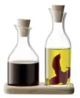  ??  ?? TWIN SET A compact oak base makes this elegant oil and vinegar set, £38 from LSA Internatio­nal, a neat addition to your dining table