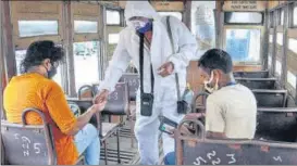  ??  ?? A tram conductor checks tickets of passengers in Kolkata
PTI