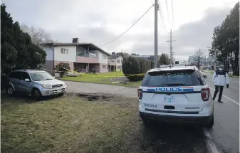  ?? THE CANADIAN PRESS ?? An RCMP officer sits outside a home surrounded by police tape where four people were found dead in Richmond. Investigat­ors said the shooting is not believed to be related to an ongoing gang conflict in the Lower Mainland.