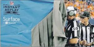  ?? AP PHOTO ?? In this August 2014 file photo, referee Tony Corrente watches an instant replay during an NFL preseason game in Denver. The NFL is making plans to speed up the pace of games, including changing how video replays are handled and using a time clock for...