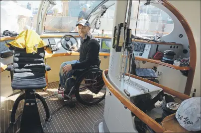  ?? COLIN MACLEAN/JOURNAL PIONEER ?? Journalist Bob Vogel at the helm of the Impossible Dream, the ship that has been his home as it sails from Miami to Quebec.